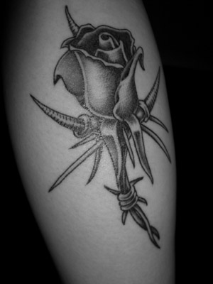 skull and rose tattoo. barbwire and thorn rose